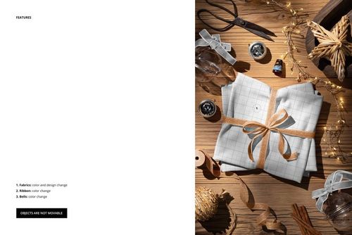 Folded jersey fabric mockup with grid pattern, tied with a brown ribbon, displayed on a wooden table with Christmas decorations.