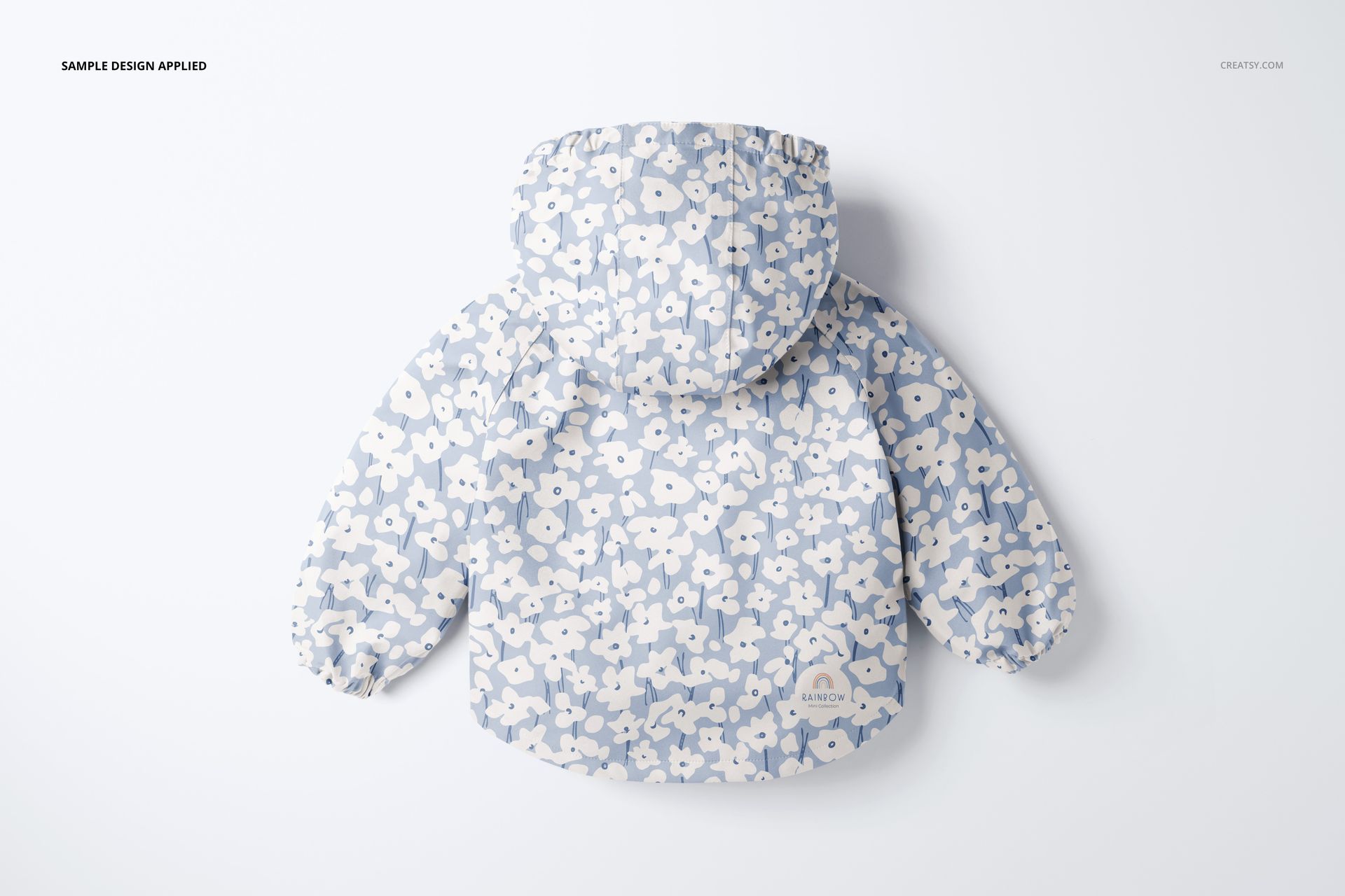 Back view of a children's raincoat mockup with a soft blue and white flower print, displayed on a white surface.