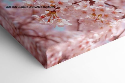 Close-up view of a cotton glossy canvas print mockup featuring pink cherry blossom flowers on a white background.