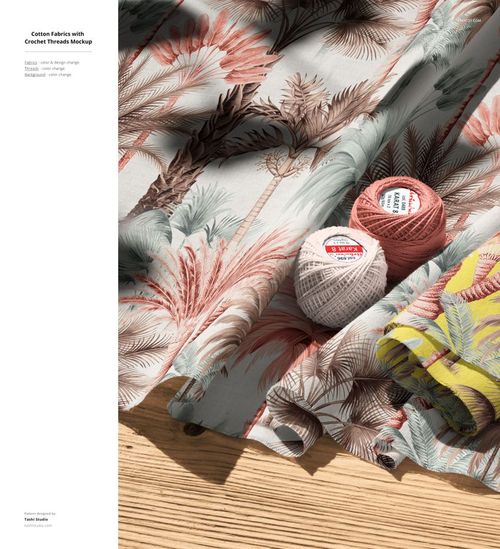 PSD mockup of cotton textiles with leafy designs, accompanied by balls of crochet thread and a layered fabric sample on light wood.