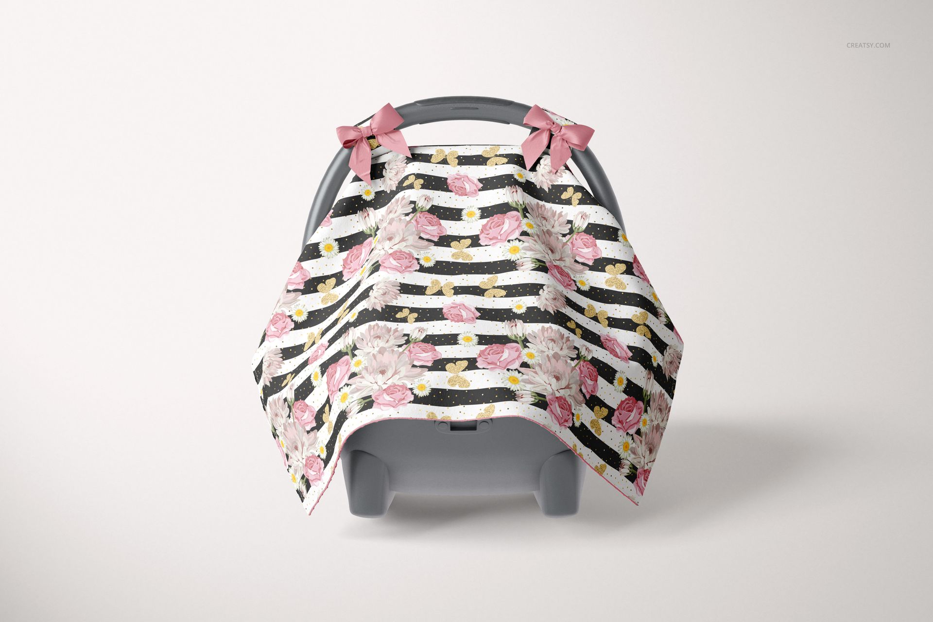 Baby car seat canopy mockup with pink flowers and black striped design, shown from the front with pink bows on top.
