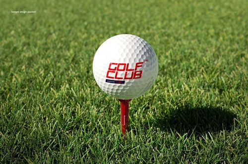 Front view of a golf ball mockup featuring a red tee and green grass background, suitable for PSD mockup designs.