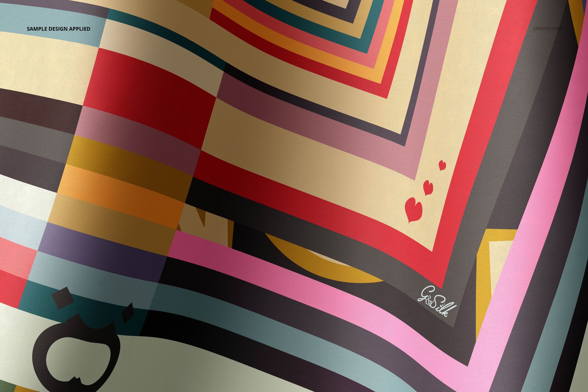 Close-up of a twill silk scarf mockup with vibrant diagonal stripes, small hearts, and abstract shapes on smooth fabric.