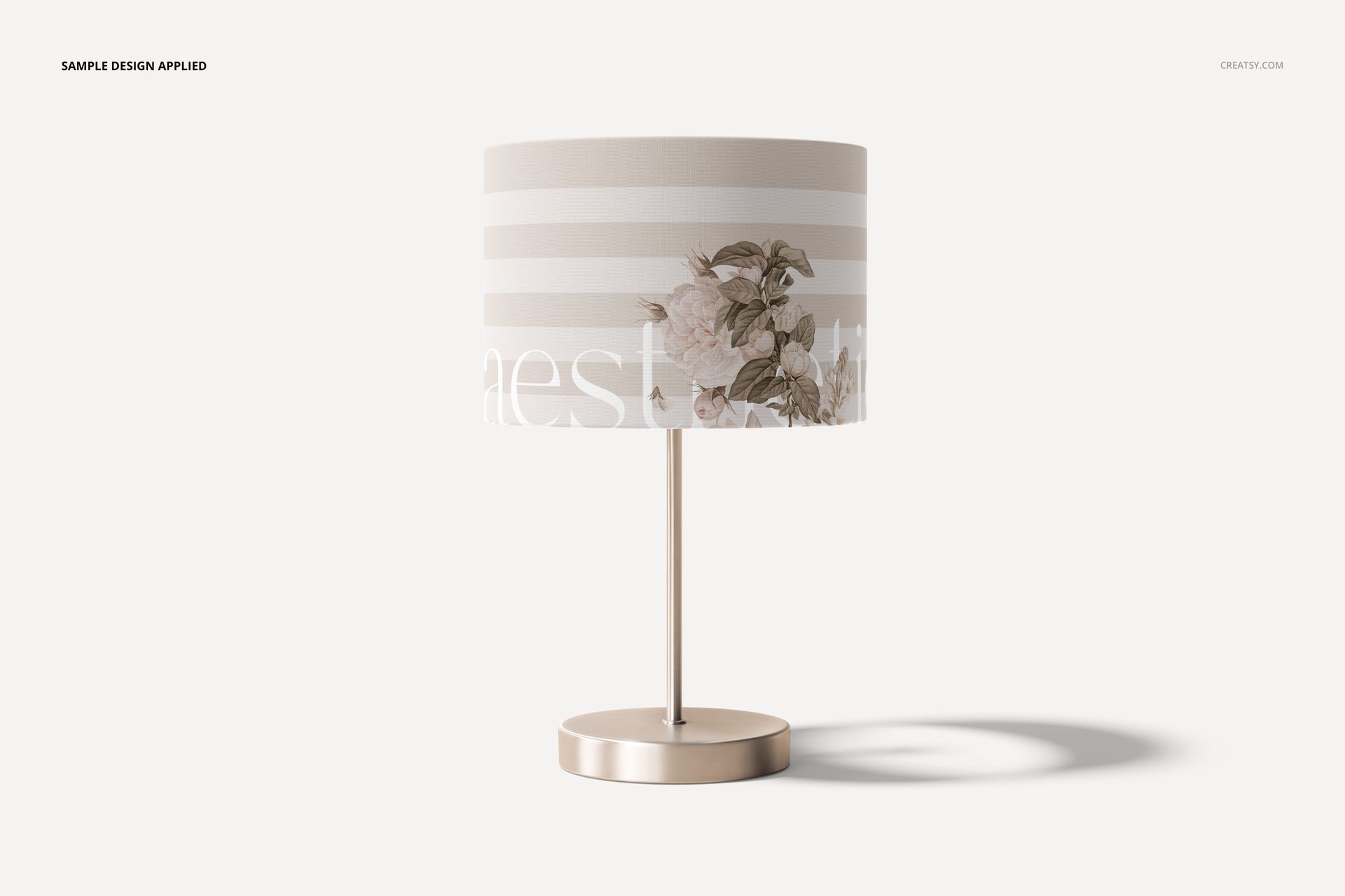 Lamp shade mockup featuring a cylindrical shape with beige and white horizontal stripes and floral design, front view.