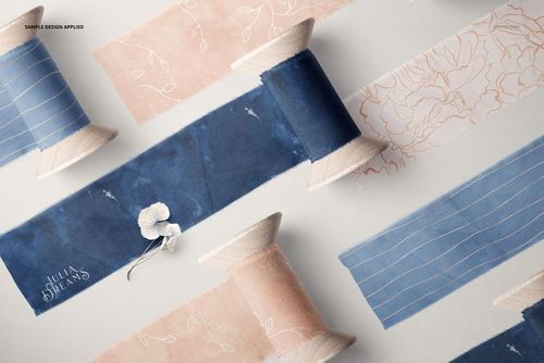 Assorted silk ribbons with floral and line designs wrapped around wooden spools, displayed in a PSD mockup scene.