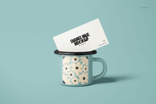 Light blue enamel mug with a floral pattern, shown from the front on a pastel blue background, featuring a card on top.