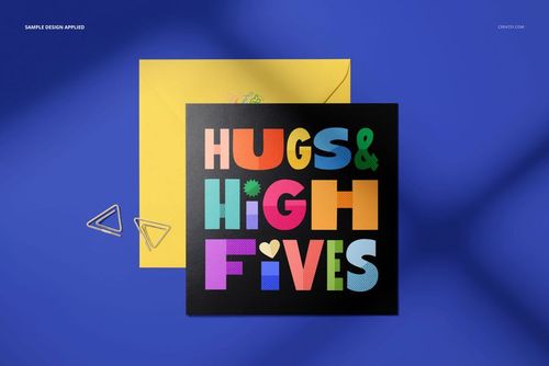 Square greeting card mockup featuring bold multicolored letters, shown with a yellow envelope and metal clips.