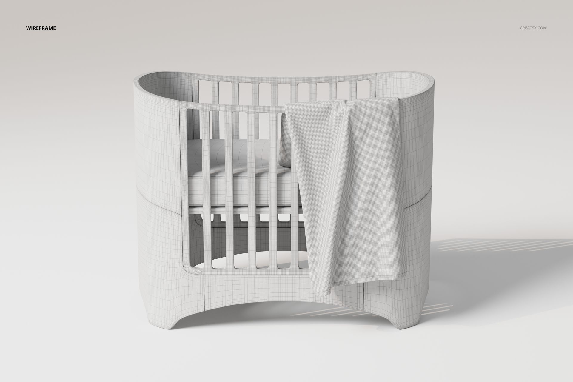Front view of a white crib with rounded edges and a large baby blanket draped over the side in a minimal scene.