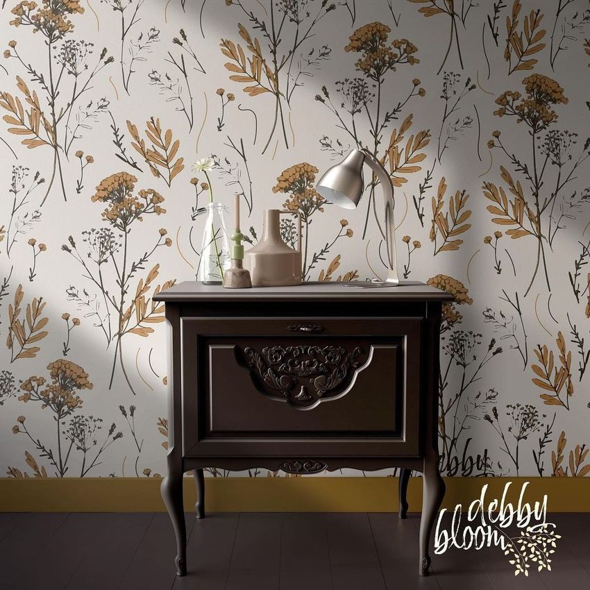 Interior scene mockup showing a dark wood side table with ornate details against a floral patterned wallpaper in neutral tones.