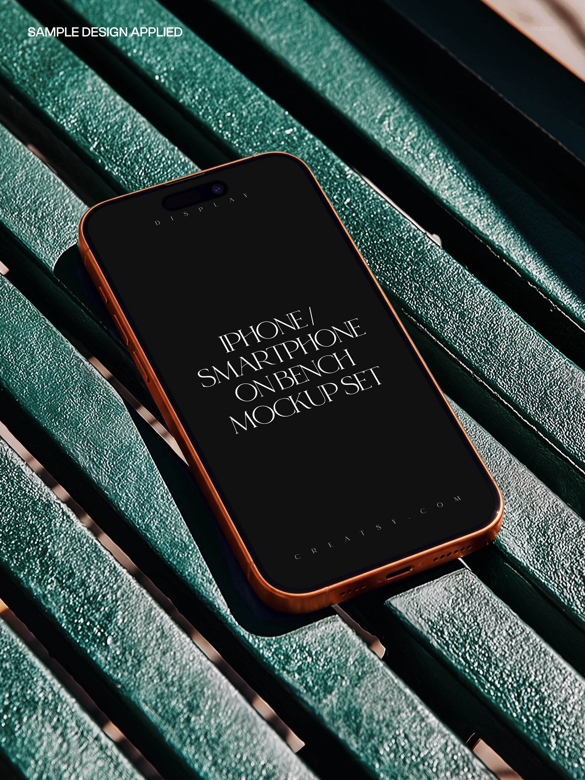iPhone smartphone with black screen displaying text, placed diagonally on green slatted park bench, PSD mockup scene.