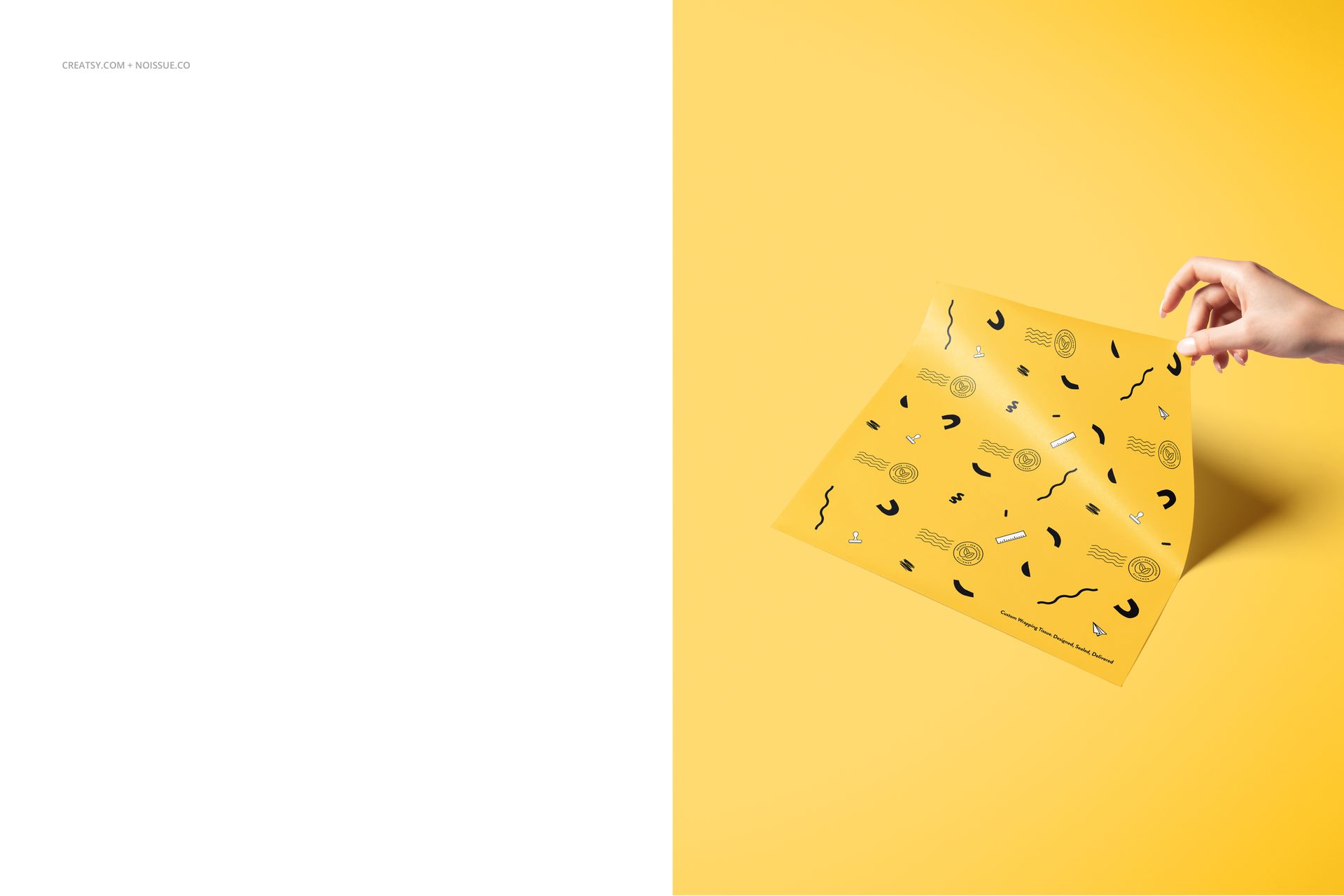 Yellow food safe paper mockup featuring black doodle designs, shown from a top angle with a hand lifting one corner.