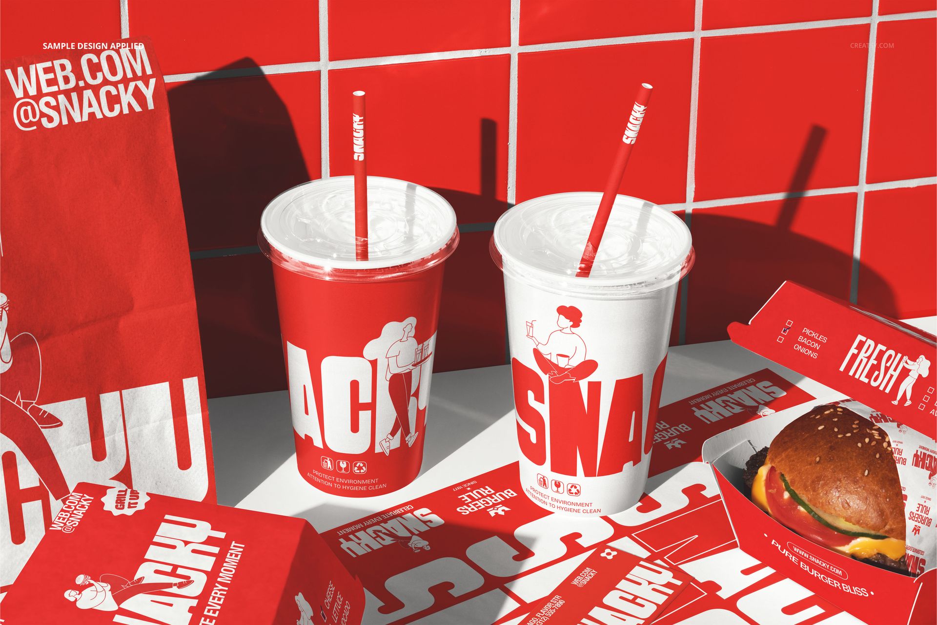 Front view of burger branding packaging mockup with red and white cups, burger box, paper bag, and wrappers on a tiled surface.