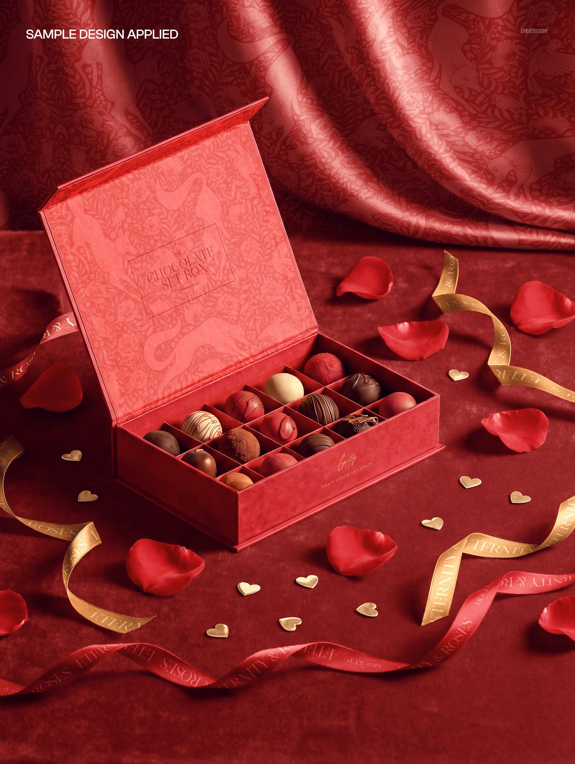 Red chocolate box mockup with various pralines inside, photographed from a top angle with decorative rose petals and ribbons.
