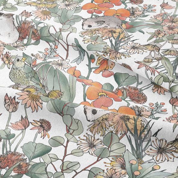 Lying fabric mockup featuring a detailed floral and animal pattern in soft green, orange, and beige tones on a white background.