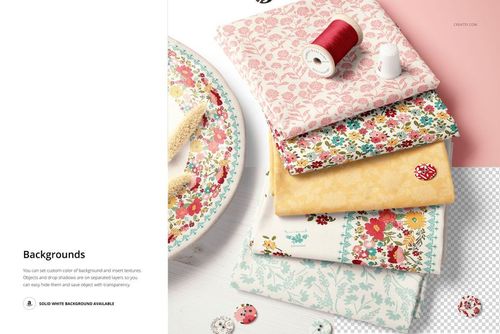 Top view of a fabric stack mockup featuring floral and decorative patterns, accompanied by a spool of red thread and buttons.