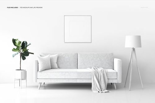 Modern living room mockup with a white couch, framed artwork, tripod lamp, and green plant on a stand.