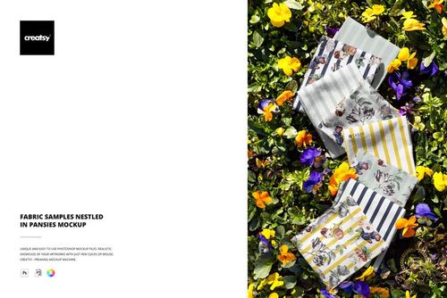 PSD mockup displaying multiple fabric samples with distinct prints placed on a bed of yellow and purple flowers.