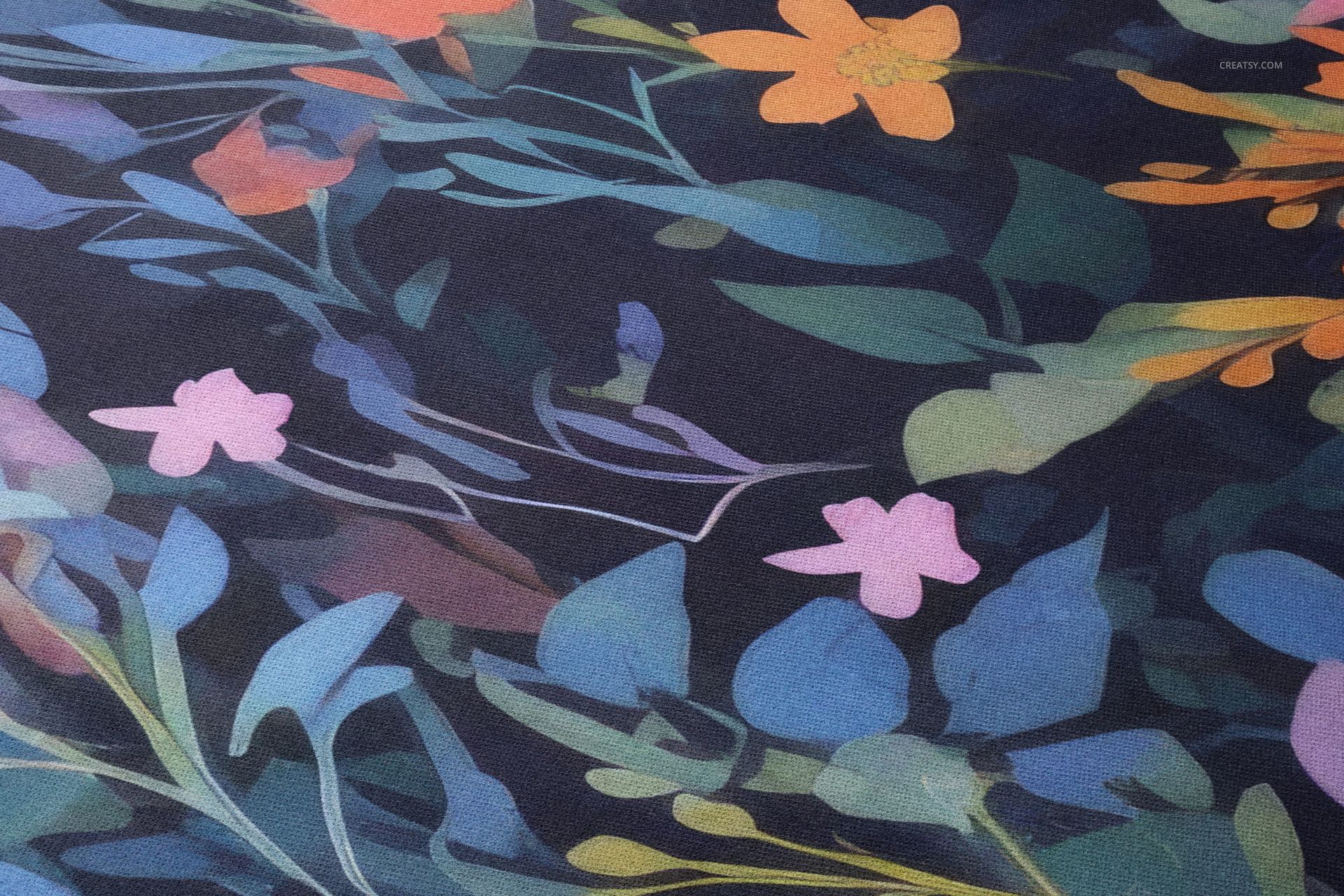 Close-up view of a woven scarf featuring a vibrant floral pattern with orange, pink, and blue leaves on dark fabric.