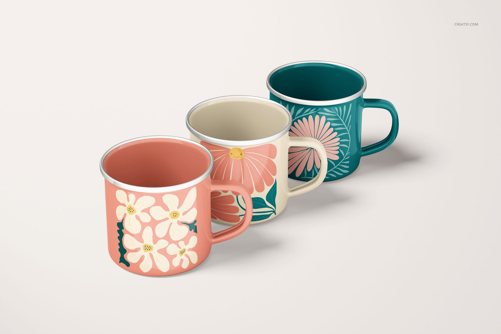PSD mockup of enamel mugs with vibrant floral motifs, arranged side by side on a neutral background.