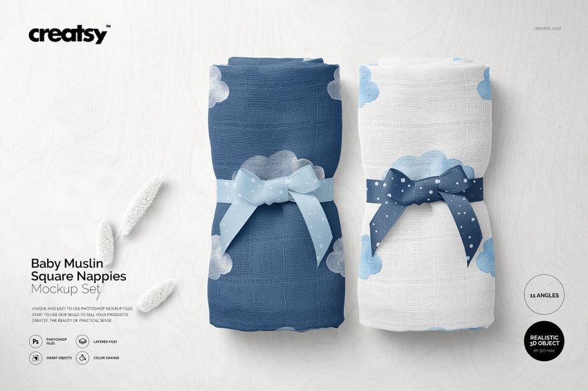 PSD mockup showing two baby muslin nappies, blue and white with cloud motifs, displayed side by side on a light background.