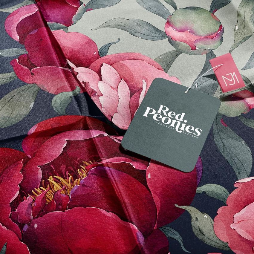 Silk scarf mockup featuring a close-up of a floral pattern with large red peonies and a dark hang tag attached.