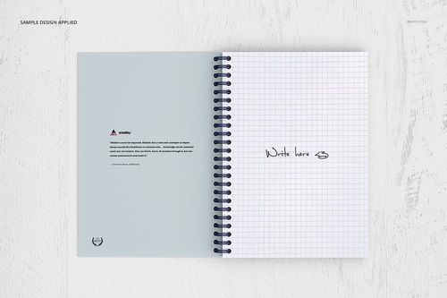 Open spiral notebook mockup with left page showing printed text and right page featuring grid pattern and handwriting.