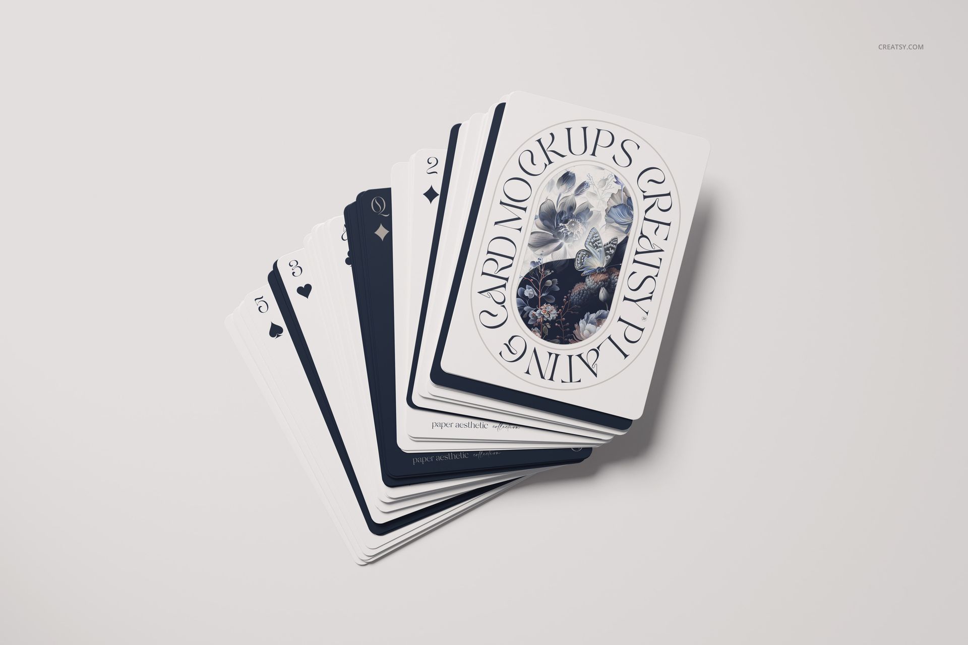 Top view of a stack of playing cards mockup with decorative floral design and assorted suits on a neutral background.