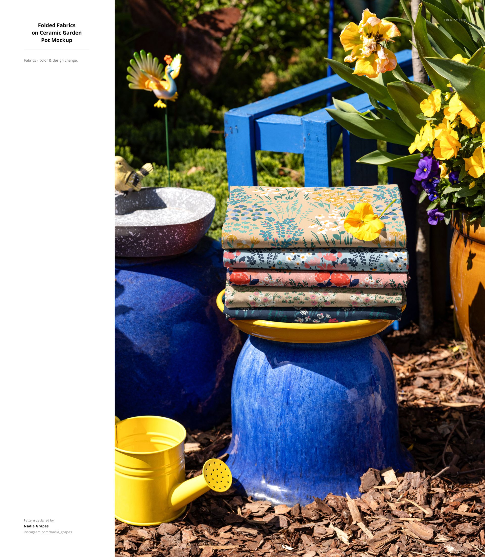 PSD mockup showing folded fabrics with various designs arranged on a blue stool, with garden tools and potted plants nearby.