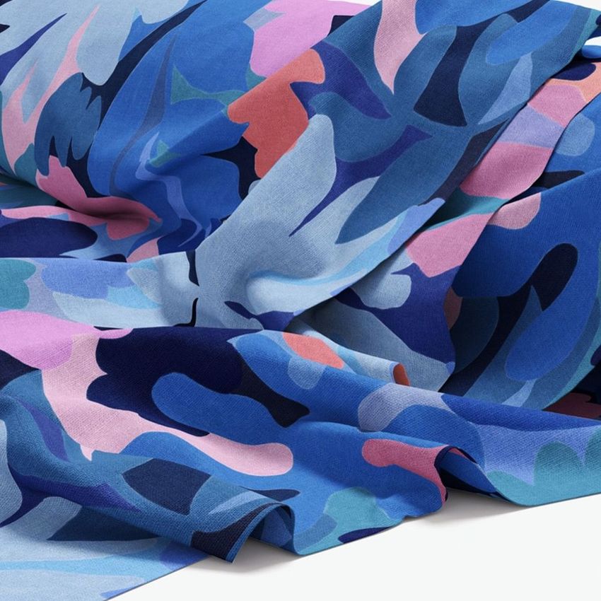 Fabric roll mockup featuring a draped textile with abstract blue, blush, and navy patterns on a white background.