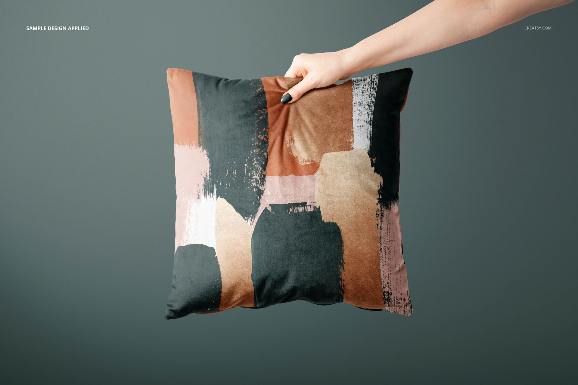 Mockup of a square cushion cover with artistic paint strokes in muted colors, presented in a minimalist setting.