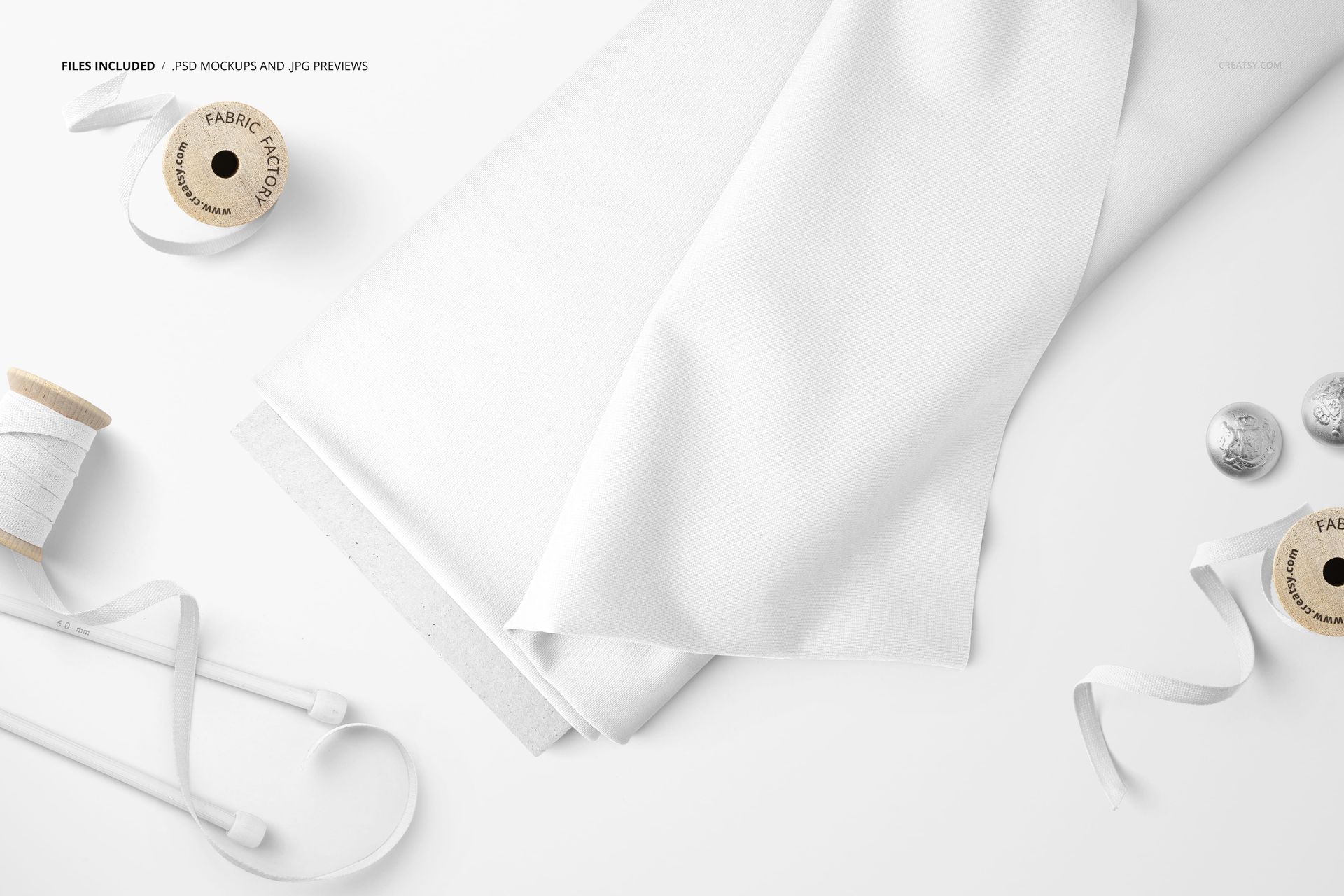 White fabric bolt and ribbons displayed with spools and buttons, shown from a top-down perspective in a mockup scene.