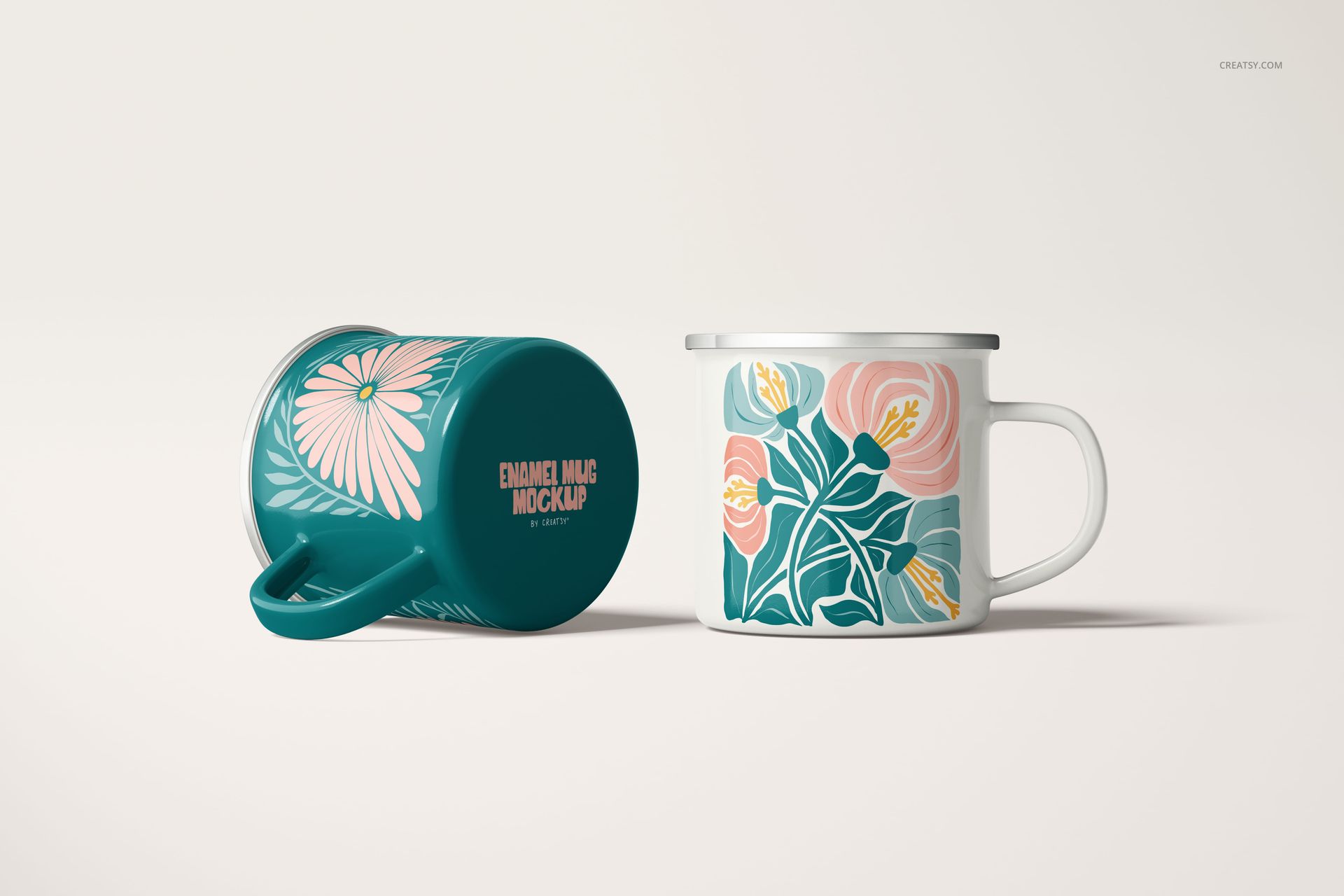 Front and side view of enamel mugs with botanical patterns, one upright and one lying down, shown in a PSD mockup scene.