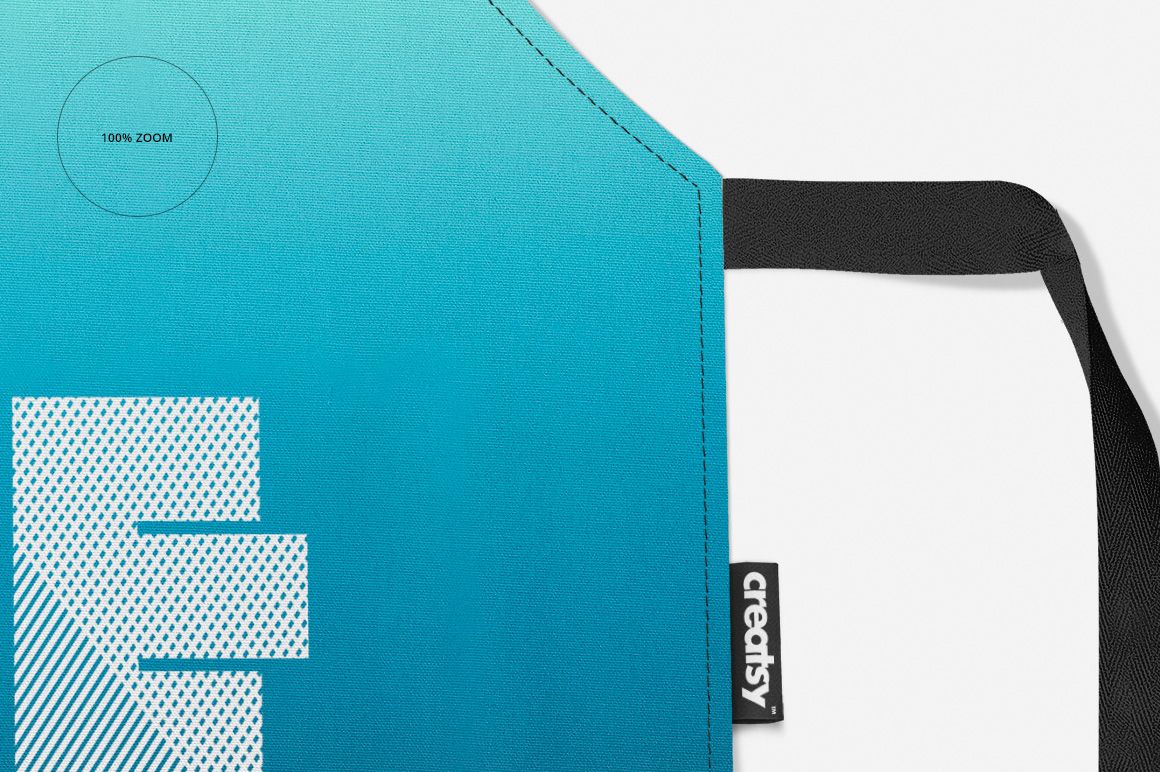 Close-up of a blue apron mockup featuring a white dotted design, black neck strap, and creatsy tag detail.
