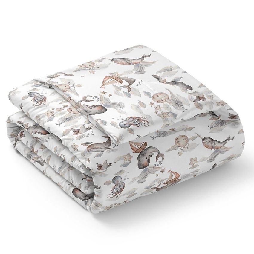 Microfiber comforter mockup featuring a folded comforter with a whimsical ocean animal pattern in soft pastel colors.