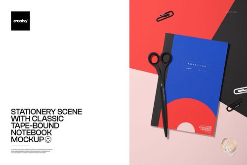 Stationery scene featuring a blue notebook mockup, scissors, and paper clips on a red and black background.