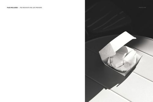 PSD mockup showing a burger box with a wrapped burger on a white table, captured from a top-down perspective.