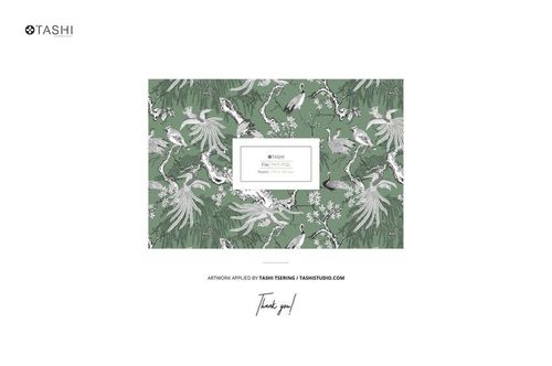 Reversible cushion mockup displaying a detailed nature-inspired design with birds and flowers on a muted green surface.