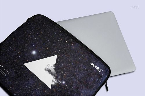 Laptop sleeve mockup featuring a cosmic print and geometric white triangle, shown with a closed silver laptop.