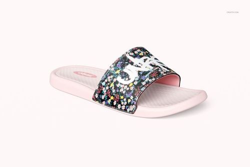 Single slide sandal mockup with a light pink sole and a black strap featuring a colorful floral pattern, front angle view.