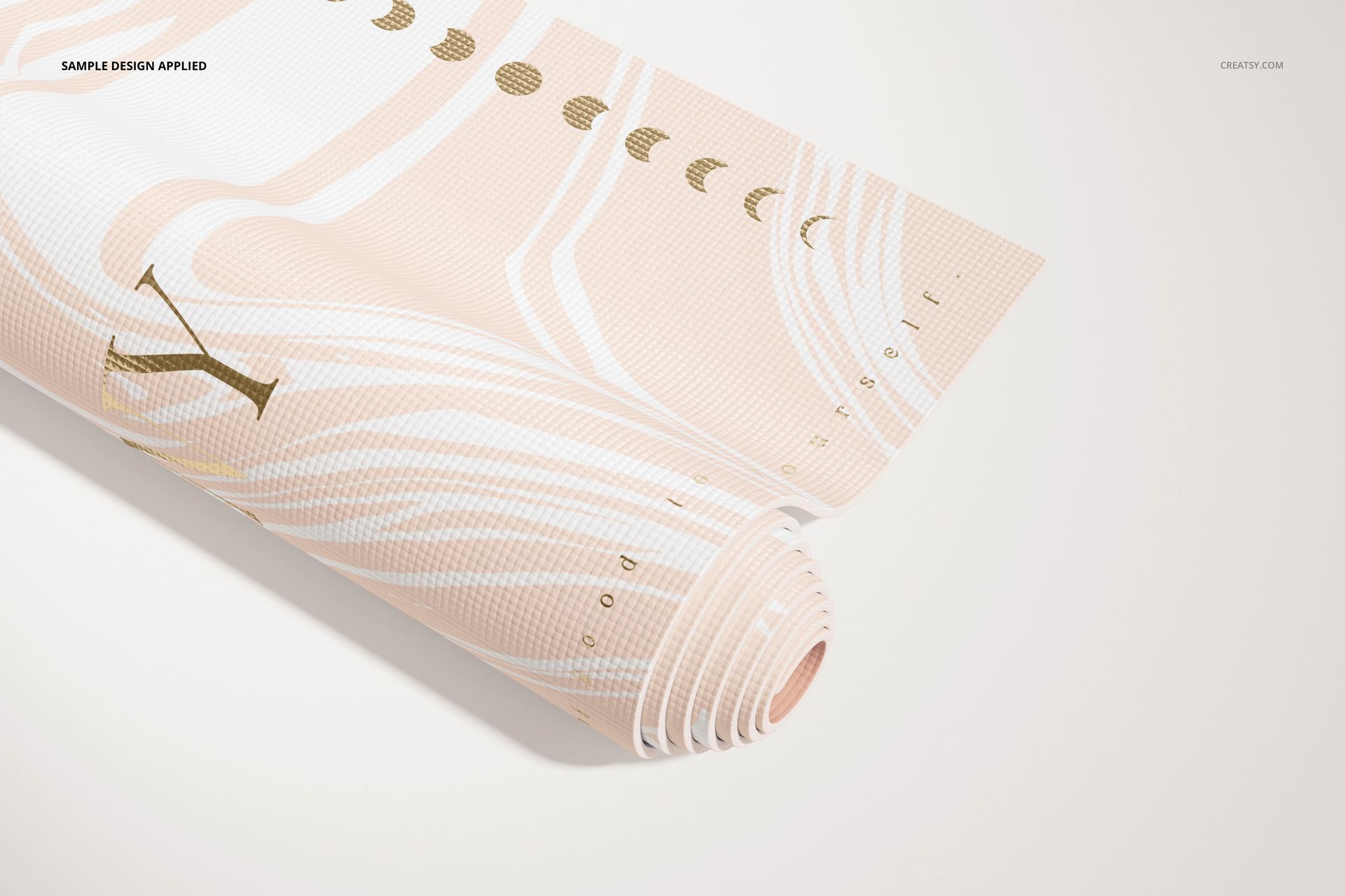 Yoga mat mockup showing a partially rolled mat with soft pastel colors and moon phase motifs on a neutral background.