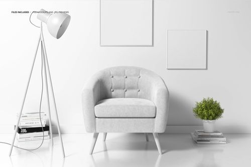PSD mockup showing a stylish armchair, decorative lamp, stacked magazines, and a small plant against a white wall.
