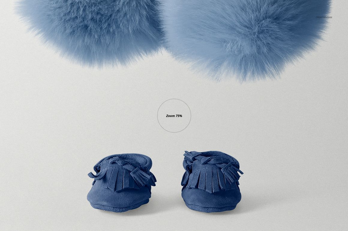 PSD mockup featuring two blue baby moccasins with tassels, placed below fluffy blue decor on a light surface.