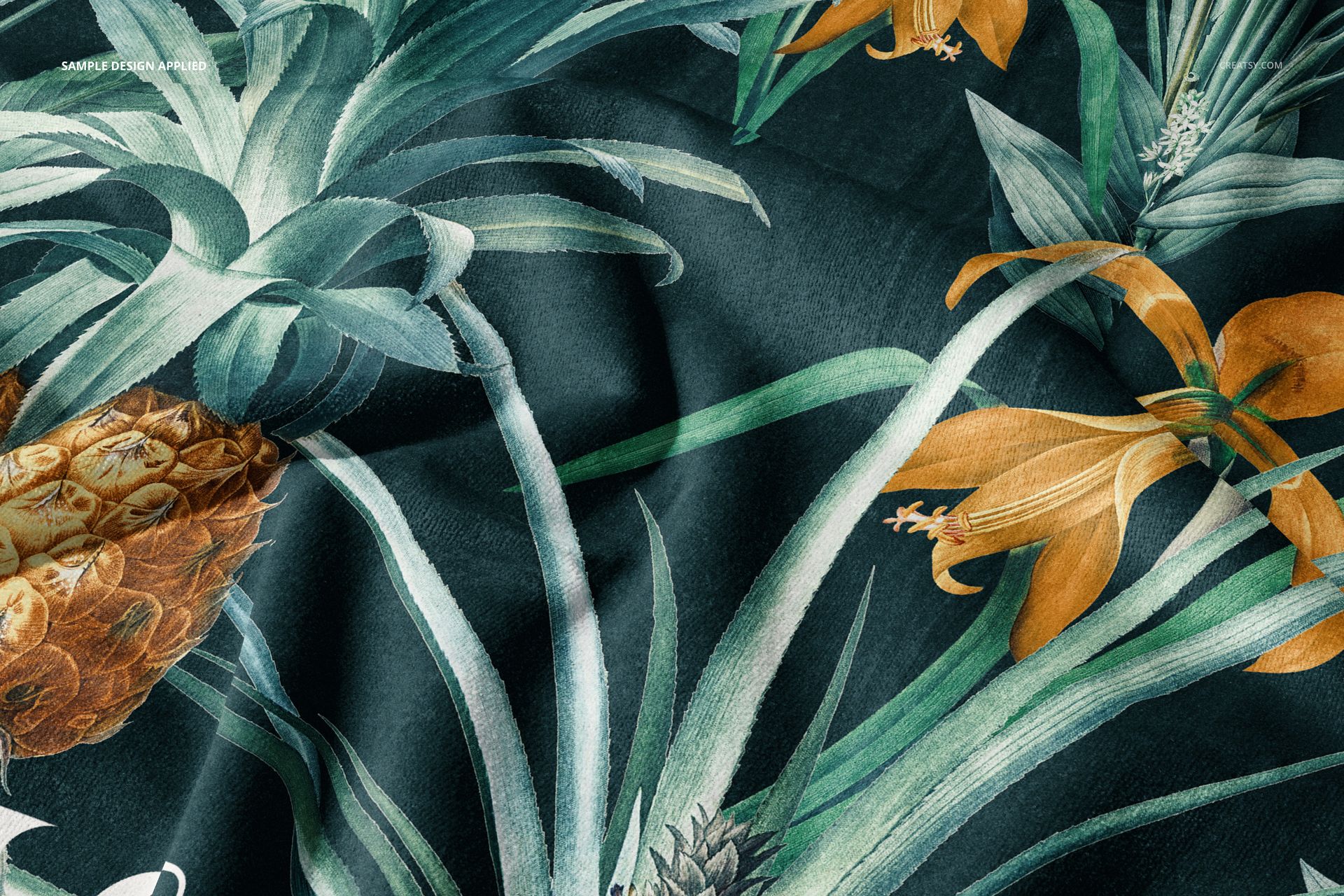 Beach towel mockup featuring a tropical pattern with pineapples and orange flowers on a dark background, close-up view.