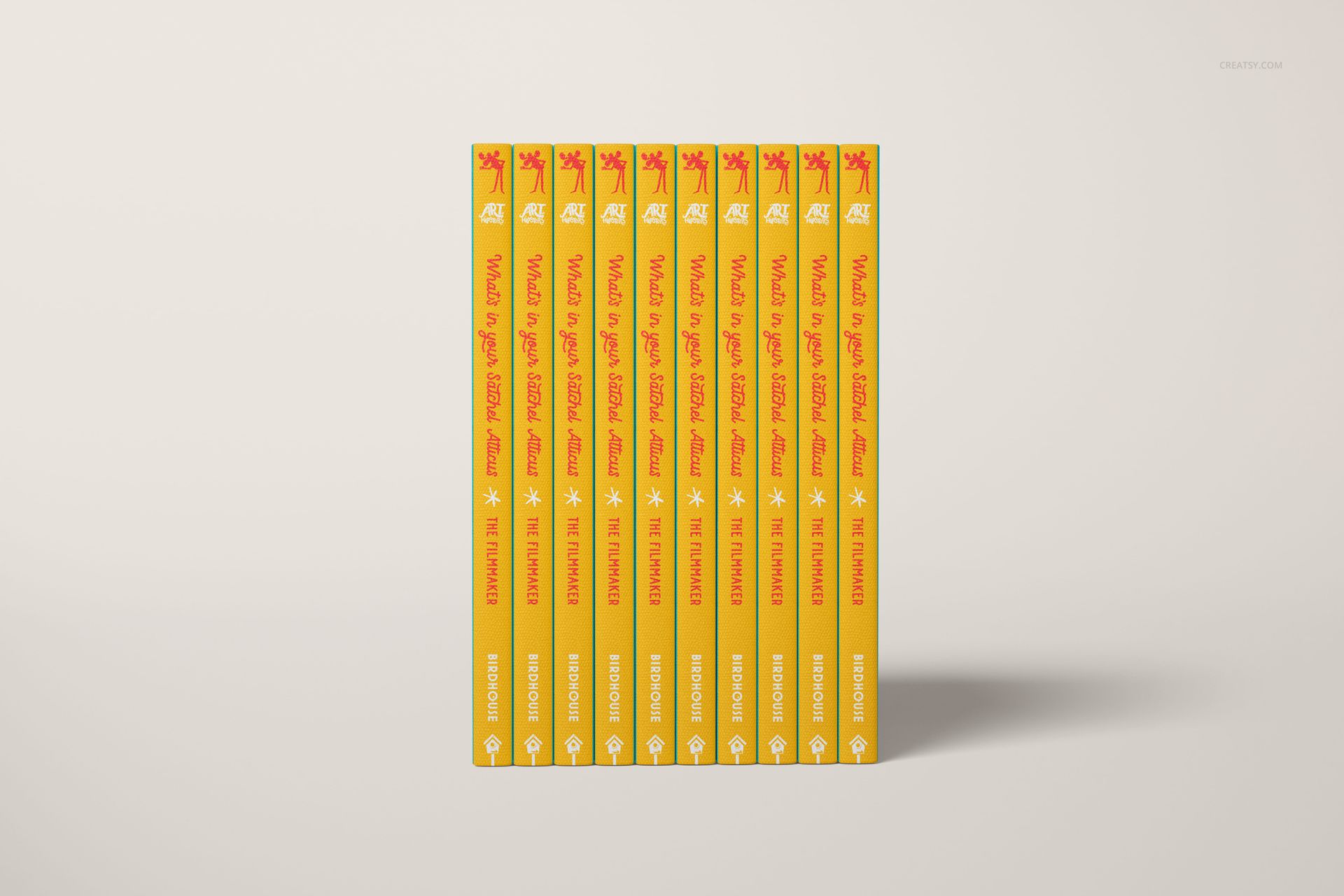 PSD mockup featuring several hardcover books with bright yellow spines and bold red titles, displayed upright in a row.