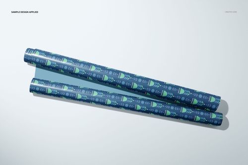Gift wrapping paper mockup with two patterned rolls in blue and green tones, displayed on a plain white background.