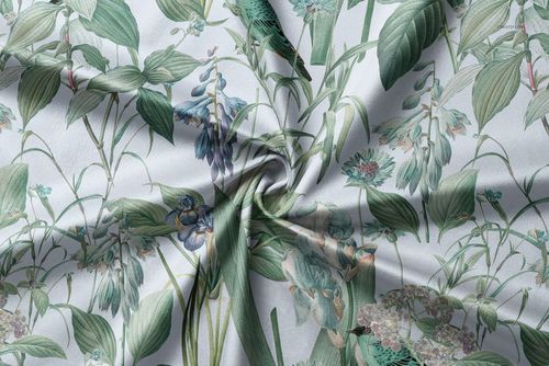 Floral patterned curtains upholstery fabric mockup with green leaves and flowers, shown in a twisted close-up view.