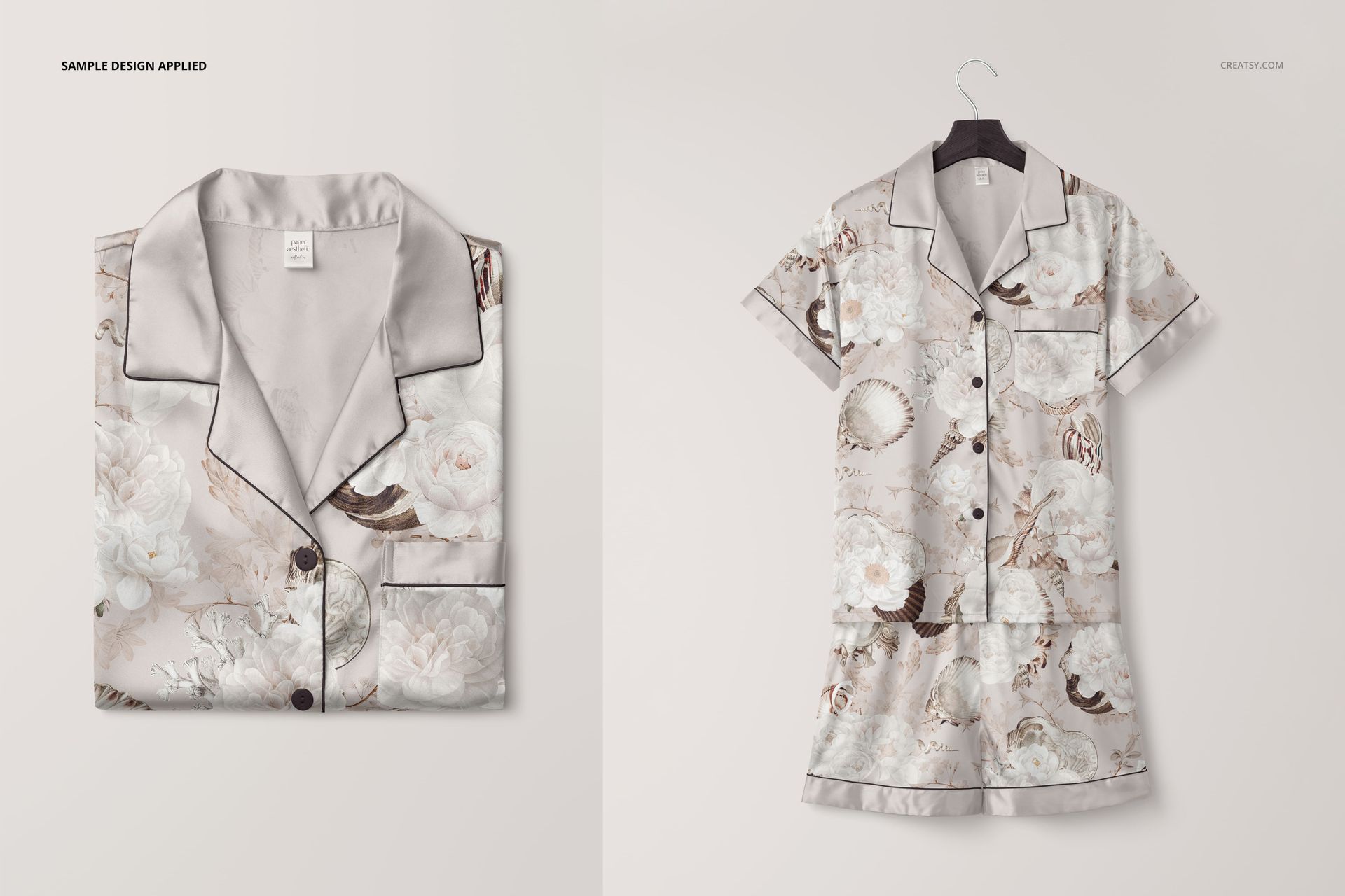 Silk short-sleeve pyjama set mockup featuring a floral pattern, shown folded and hanging on a hanger against a light background.