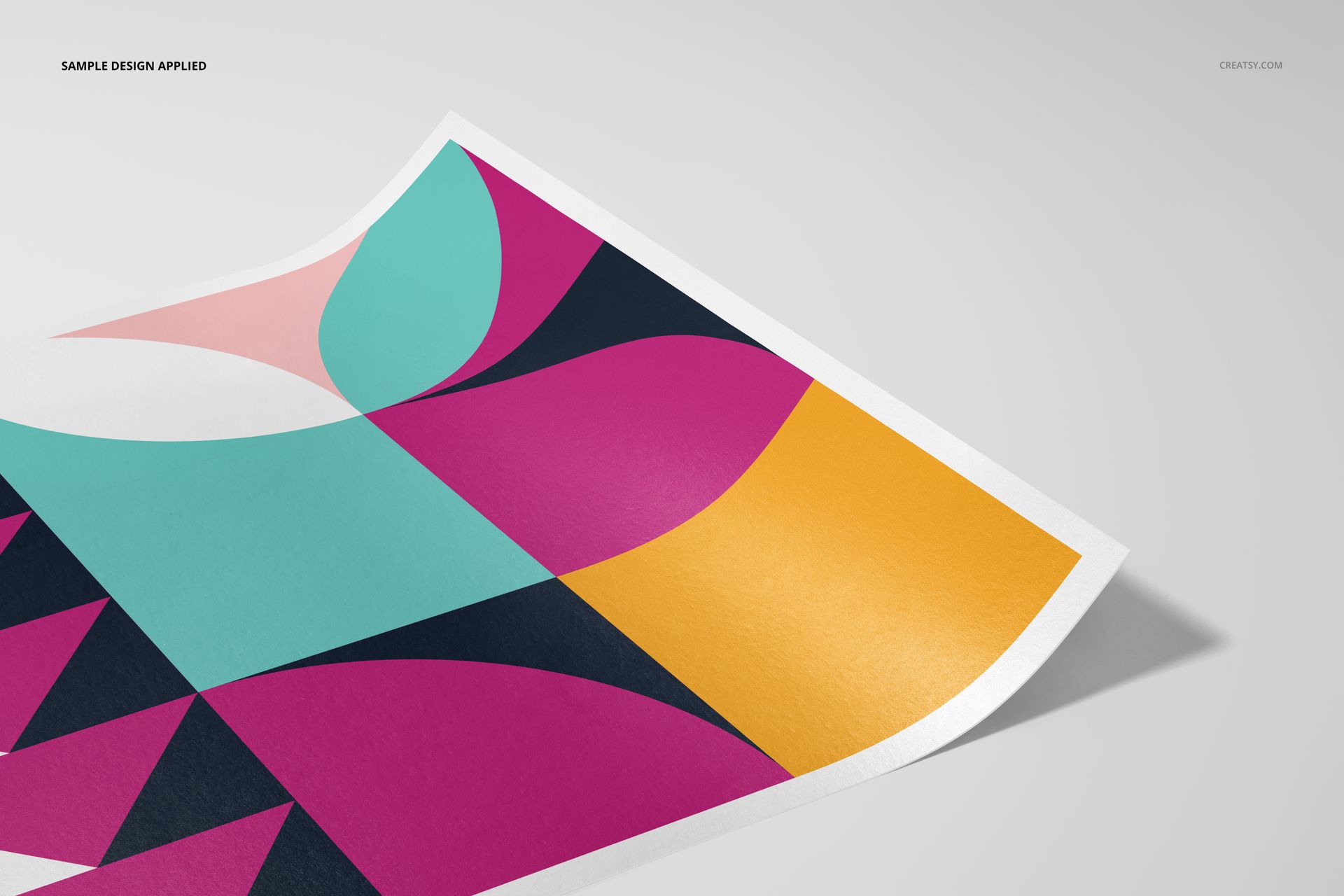 A3 fine art print mockup featuring a geometric abstract design in pink, teal, yellow, and navy, angled on a light surface.