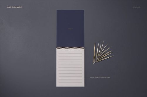 A4 vertical spiral notebook mockup with a navy blue cover and lined white pages, viewed from above on a dark surface.
