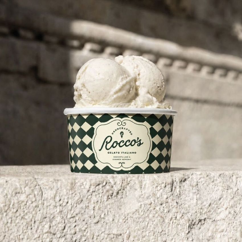 Ice cream paper cup mockup featuring two scoops of vanilla gelato in a patterned cup, photographed outdoors on a stone surface.